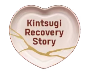 A heart shaped kintsugi serving plate with 'Kintsugi Recovery Story' written on it.